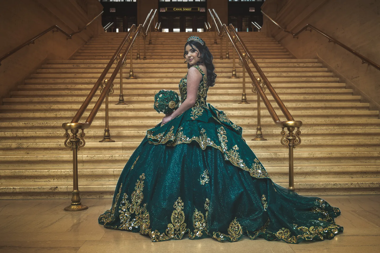 Quinceañera in an emerald gown on the Union Station staircase
