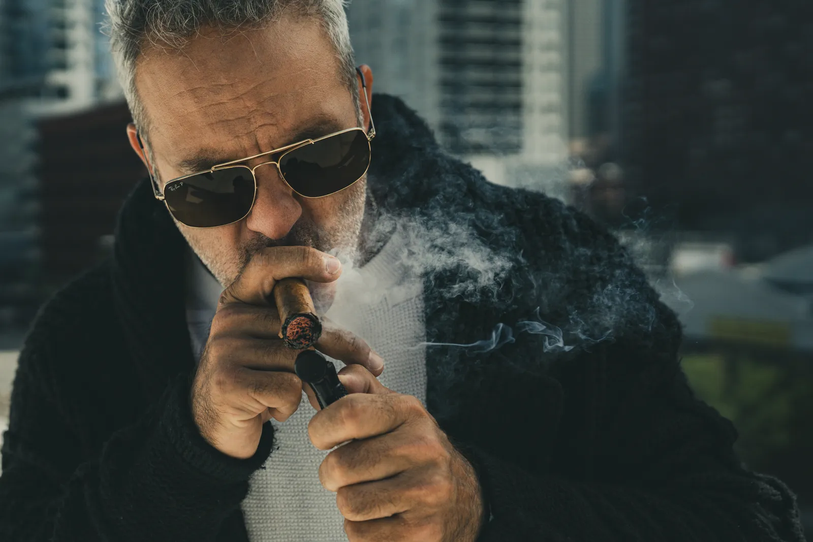 Moody brand portrait with cigar smoke