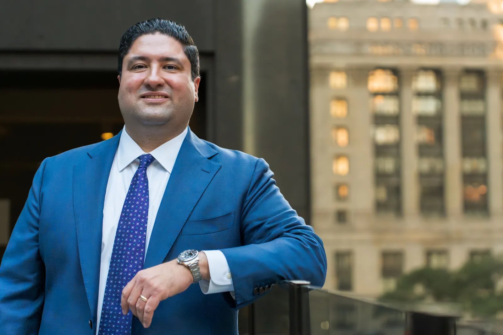 Executive portrait in a blue suit with the Chicago skyline